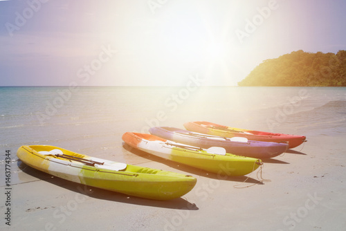 Couple, kayak and ocean with paddle in sunset for travel, hobby or outdoor holiday in water, lake or nature. rowing boat in sunshine for canoeing, adventure or journey at sea