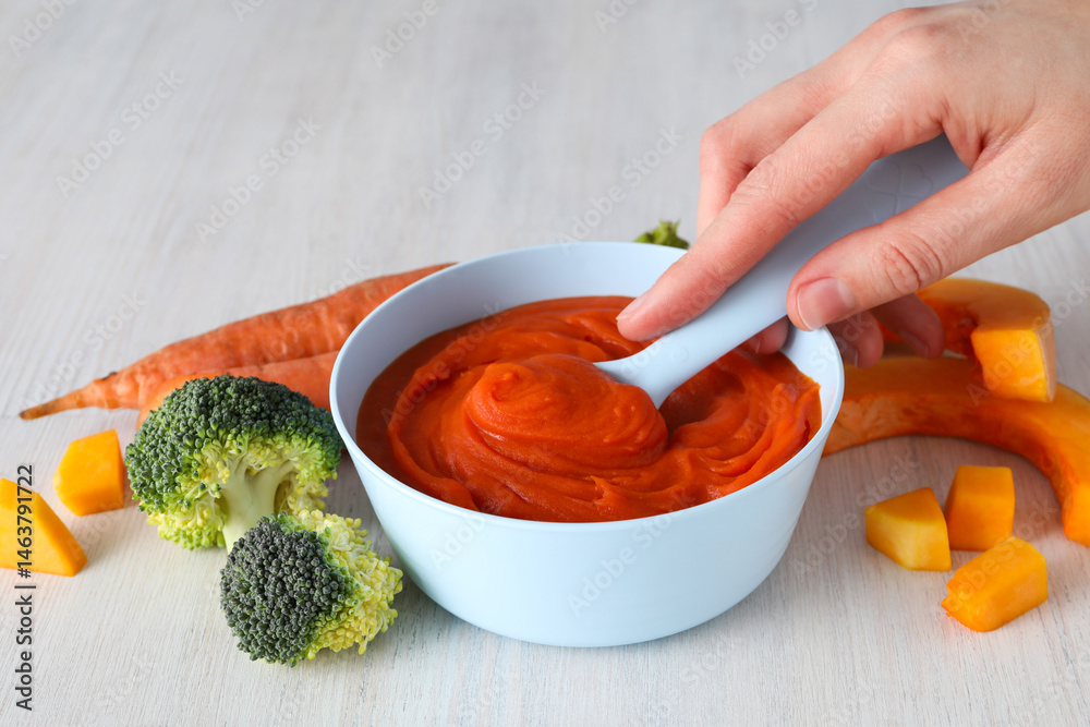 Children's vegetable and fruit puree, on a light background.