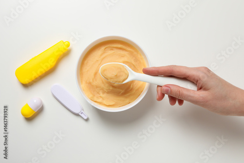 Children's vegetable and fruit puree, on a light background.