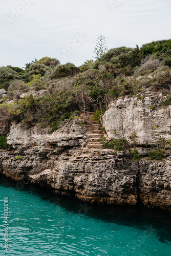 Rocky cliff with ancient stone steps, Cala en Brut, Menorca