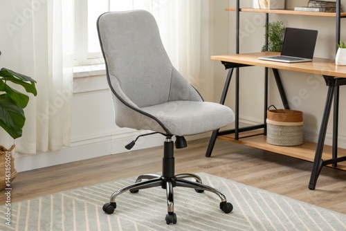 Modern ergonomic office chair in a bright home workspace with a desk, laptop, and minimalist decor.
