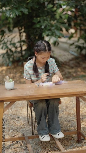 Asian girl making handmade necklace accessories