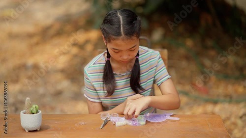 Asian girl making handmade necklace accessories