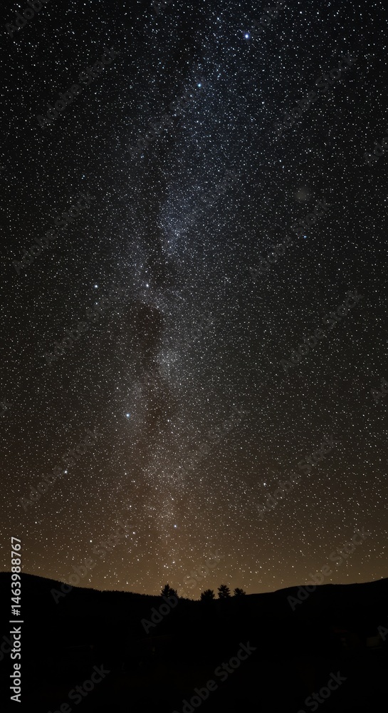 Fototapeta premium Night Sky Full of Stars Over a Dark Mountain Landscape