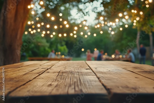 Rustic wooden table with blurred garden party background for product display and promotional content.