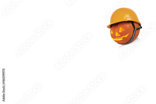 Orange pumpkin with glowing eyes in yellow construction helmet. Safety concept. Transparent background. Copy space