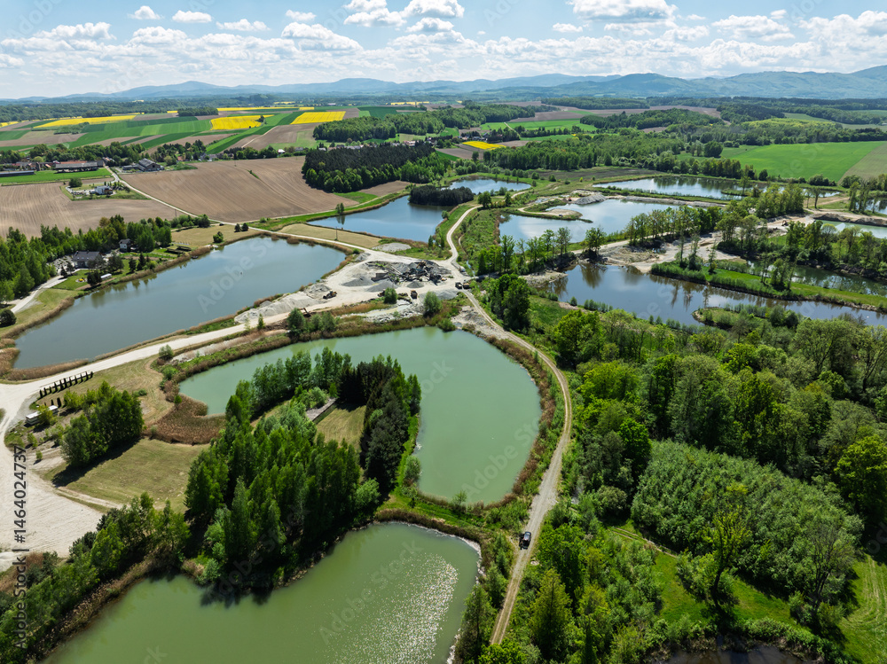 Aerial drone view of beautiful yellow fields rapeseed.Village country farming shapes in fields. Spring fields of yellow blooming rapeseed, growing plants. Fields in the Opole village from a drone.