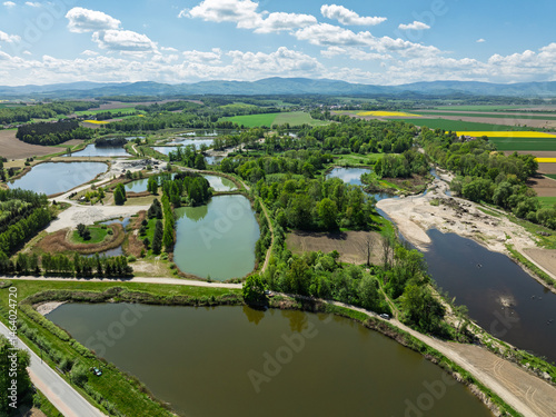 Aerial drone view of beautiful yellow fields rapeseed.Village country farming shapes in fields. Spring fields of yellow blooming rapeseed, growing plants. Fields in the Opole village from a drone.