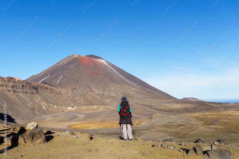 Tourist enjoying the view of Mt Ngauruhoe. Tongariro Alpine Crossing. Tongariro National Park. New Zealand.