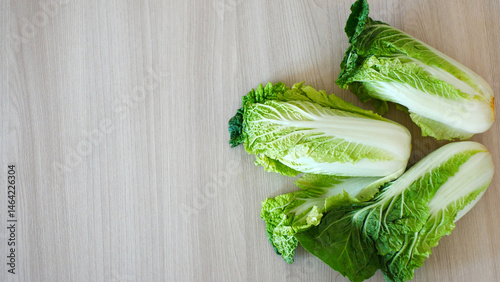 Three nice Chinese cabbages on a wooden surface