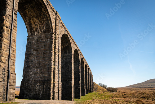 A sunny spring HDR image of the eastern half of the Ribblehead Viaduct, from the south, showing the curve of the structure. England photo