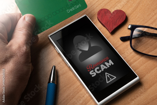 Romance scam concept: man use a credit card to pay for a love scam