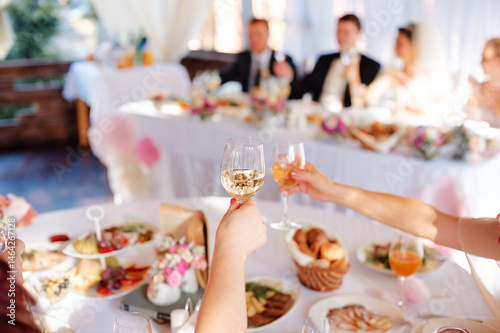 Elegant Wedding Celebration with Guests Toasting at Reception..