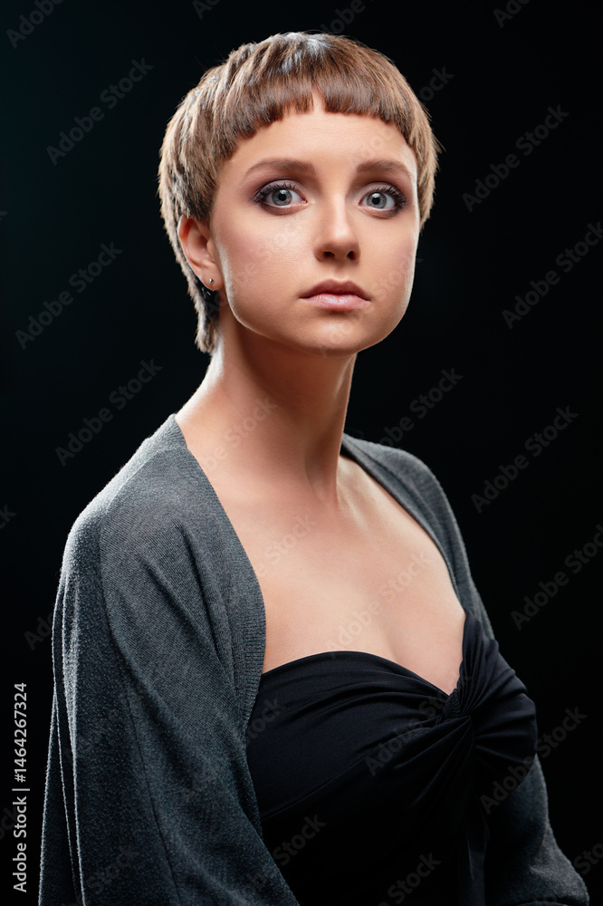 Fototapeta premium Portrait of a Woman with a Modern Hairstyle and Elegant Expression..
