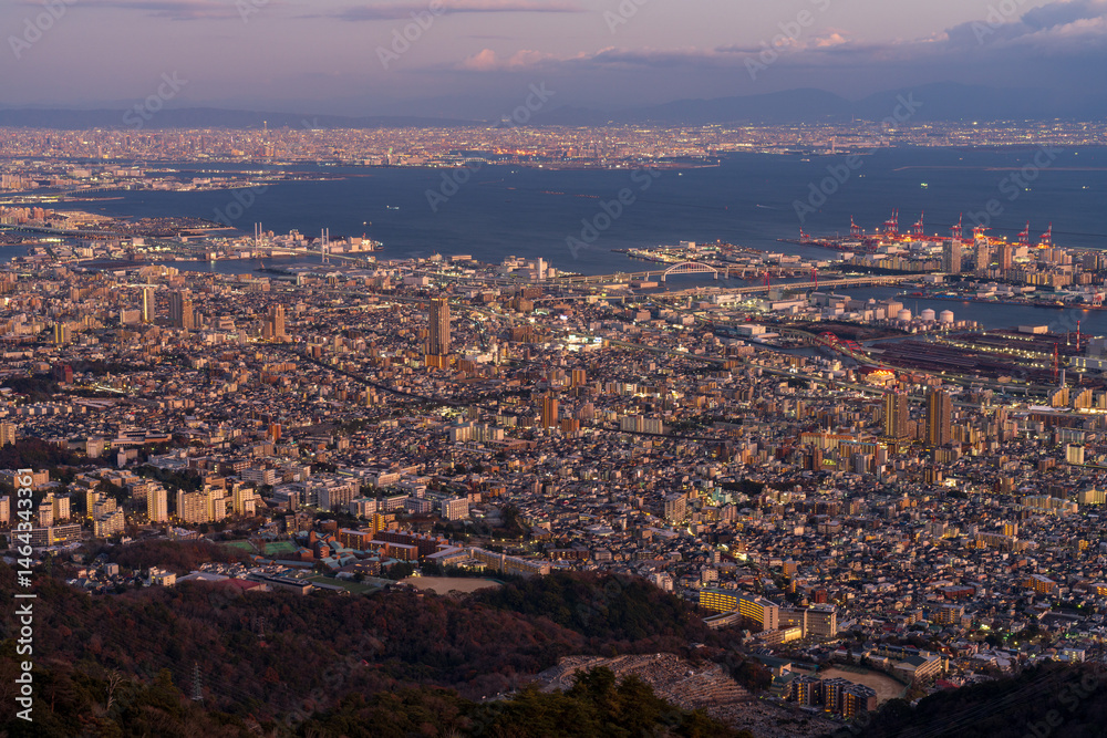 Obraz premium Cityscape of greater Kobe and Osaka area city view from the top of Maya-san in Kobe at twilight time