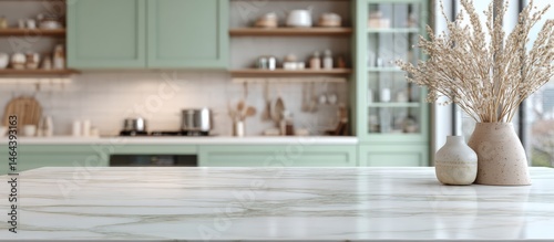 Obraz na płótnie Modern kitchen with green cabinets, marble countertop, and decorative vases with dried flowers, creating a cozy and stylish atmosphere. w salonie