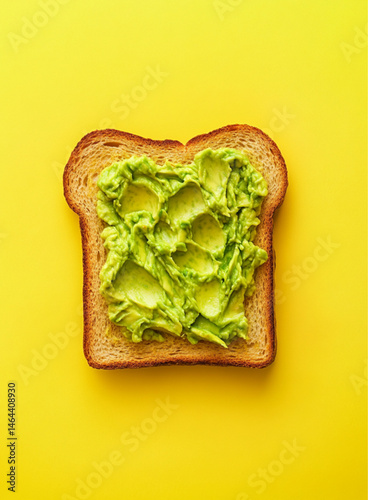 Obraz na płótnie smashed avocado on toasted slice of sandwich bread, empty background, top view, yellow background w salonie
