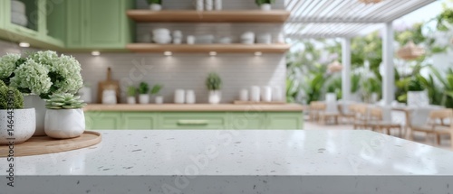 Modern kitchen with green cabinets, a white countertop, potted plants, and an open, airy dining area with natural light and greenery.