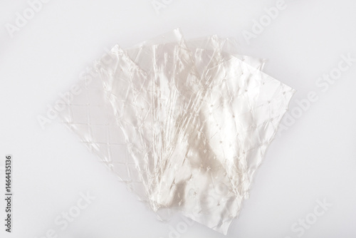 Obraz na płótnie Several translucent sheets of leaf gelatin are slightly overlapping on a light gray background w salonie