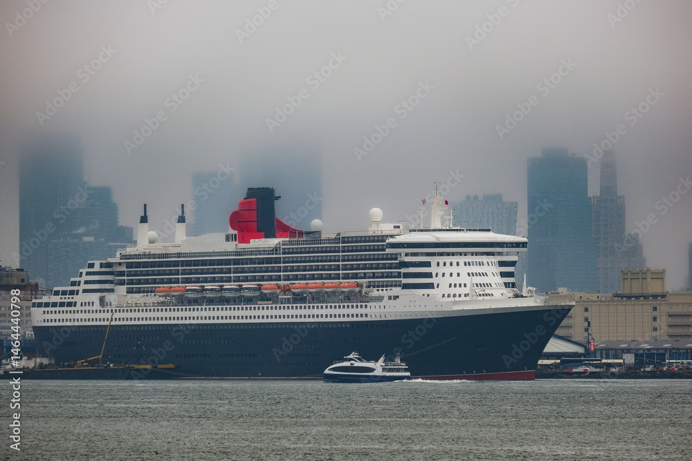 Luxury ocean liner cruiseship cruise ship Queen Mary docked at terminal in Brooklyn on grey rainy cloudy misty day after Transatlantic Crossing in New York City