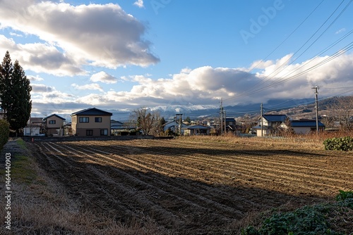 Rural Japanese Village Landscape With Farmland And Mountains