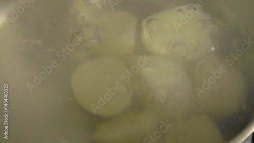Potatoes are boiled in water. A pot of boiled potatoes.