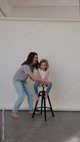 Fun moments captured of a child playing during a photoshoot with a parent