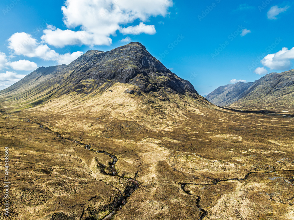 Buachaille Etive Beag and Three Sisters in Glencoe over Moors and Road A82 from a drone, Highlands, Scotland