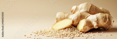 Food composition with a fresh ginger root on a soft beige background with a scattering of sesame seeds in neutral color palette and minimalist style for  food packaging, organic ingredients. 