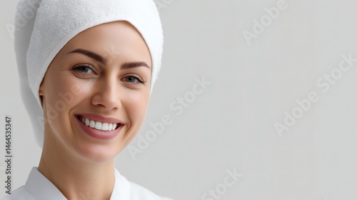 Obraz na płótnie Woman with towel on head smiling, Spa client with clean white towel, Concept image for beauty, relaxation or skincare service w salonie