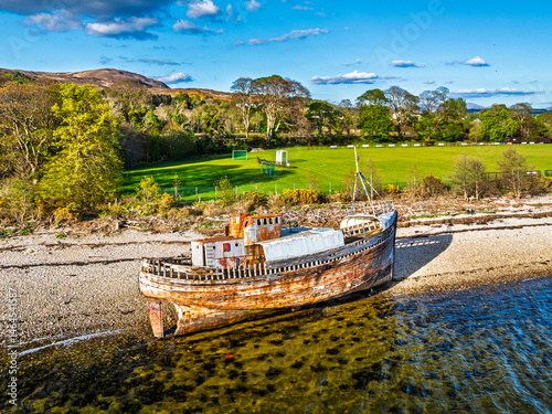 Obraz na płótnie View of Corpach Wreck or Old Boat of Caol and Nevis Range Mountains from a drone, Caol Beach, Corpach, Fort William, Highland, Scotland w salonie