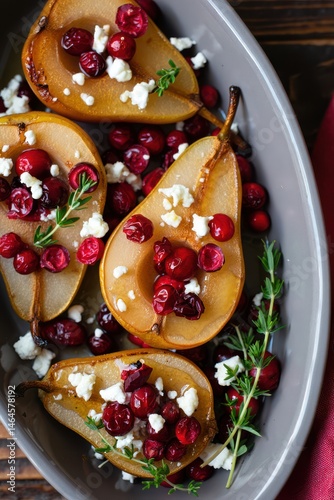 Obraz na płótnie Roasted pears are beautifully arranged in a serving dish, garnished with fresh cranberries and crumbled goat cheese, perfect for a holiday celebration or gathering w salonie