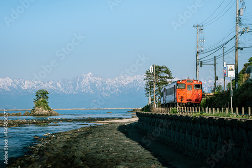 Local Train Passing Amaharashi Coast with Tateyama Mountains in the Background – Toyama, Japan, May 8, 2025