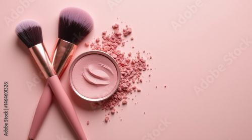 Compact round powder blush with brush on pastel pink background, top view, flat lay