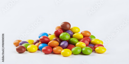 Pile of colorful chocolate coated candy isolated on white background