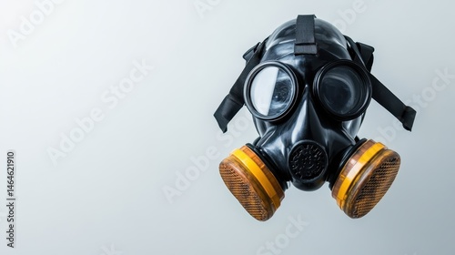 A stark black gas mask with a minimalist design showcases the tension between survival and industrialization in a world facing environmental challenges and health risks.