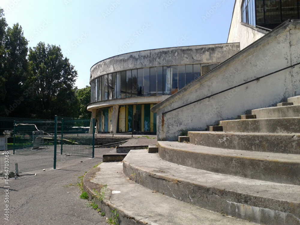 Old abandoned grandstands of a racetrack with tall stairs damaged