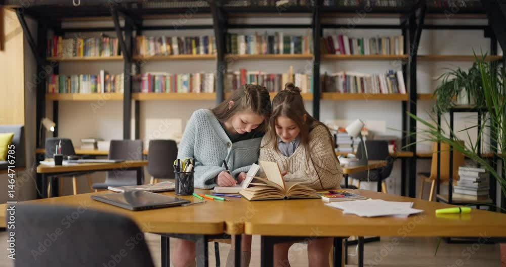 Two schoolgirls immerse themselves in a creative project Two schoolgirls immerse themselves in a creative project