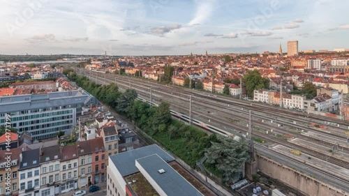 Wallpaper Mural Aerial timelapse of Brussels North station railway tracks with trains arriving and departing. Schaerbeek evening cityscape panorama featuring red rooftops, industrial areas and a cloudy sky. Belgium Torontodigital.ca