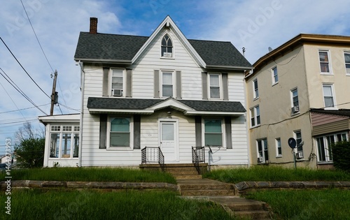 A classic, white two-story home with a covered front porch and a well-maintained lawn near Avondale, Pennsylvania, U.S.A