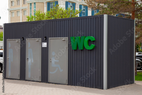 Outdoor toilet cubicles marked WC
