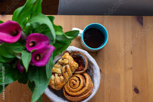 An aromatic symphony of pastries beside vibrant calla lilies, perfect for Hygge moments and Danish Fastelavn indulgence