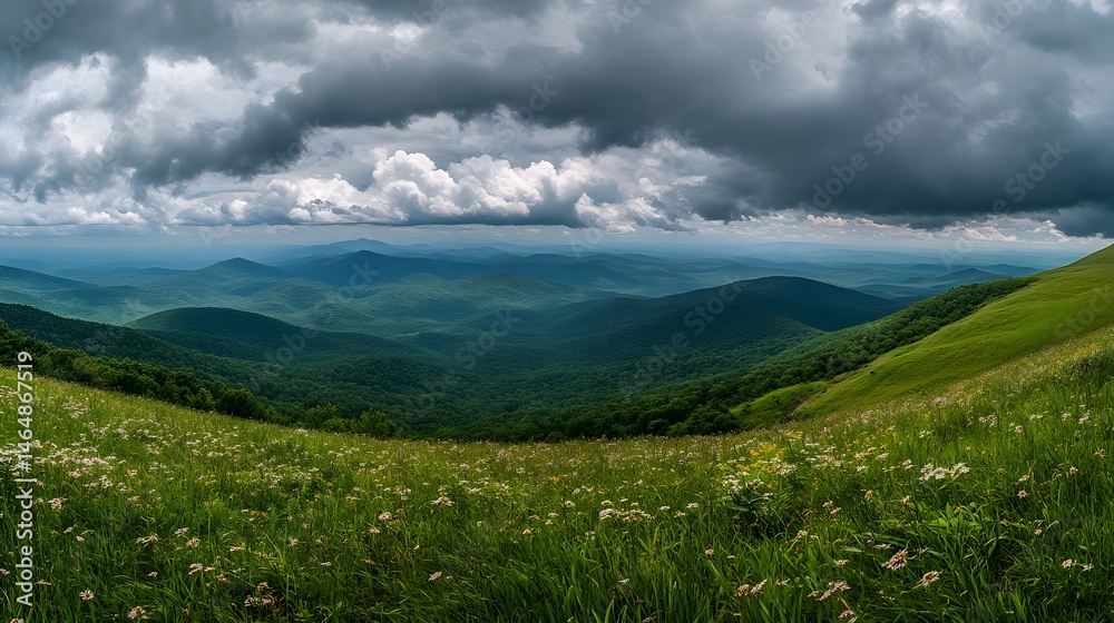 Fototapeta premium Vast mountain vista under dramatic sky.