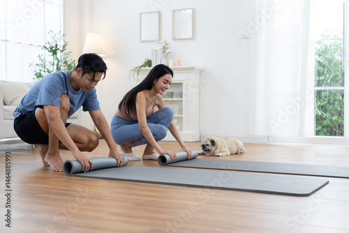 Wallpaper Mural Couple rolls up their yoga mats after completing a morning workout session at home. Their pug lies nearby, enjoying the cozy atmosphere of bright living space. Torontodigital.ca
