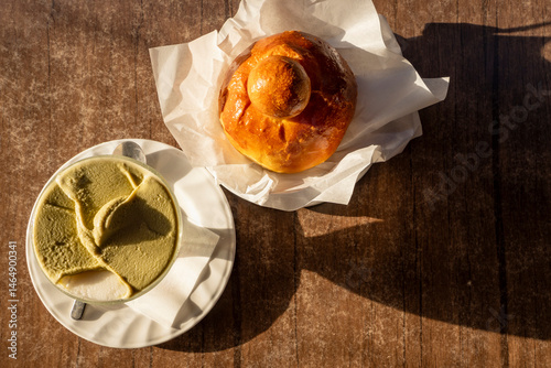 Top view of Sicilian granita with pistachio and almond flavors served with brioche in morning light
