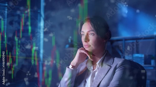 Confident beautiful woman in elegant suit resting chin on hand while glowing stock market charts floating in air. Digital financial data reflecting on face. Investment strategy. Economic forecasting.