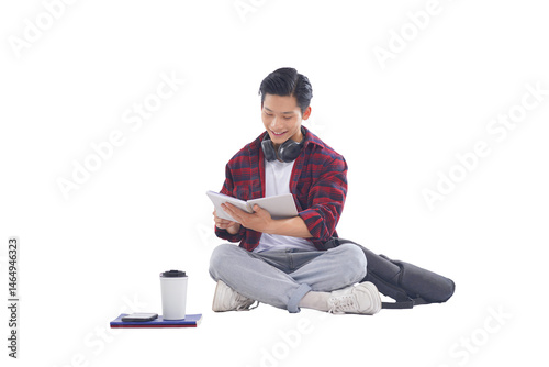 portrait of asian male student sitting posing on white background