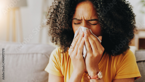 Sofa, woman and sick with tissue for blowing nose, allergy and inflammation of sinus in living room. Home, female person and medical virus with sneezing for influenza, cold and illness on couch