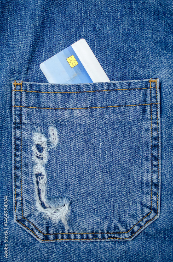 Credit card in blue jeans pocket close up