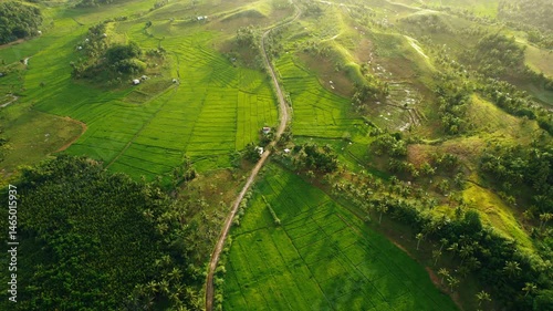 Beautiful 4K aerial drone footage capturing the golden hour over the farmlands and rolling hills of Siargao, Philippines. This cinematic clip features expansive agricultural landscapes, sunset light, 